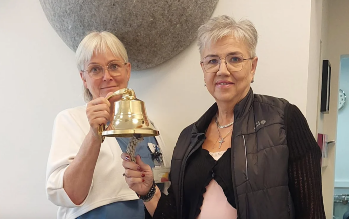 Guðbjörg Hjaltadóttir, sjúkraþjálfari á göngudeild, tekur við bjöllunni frá Erlu G. Sigurjónsdóttur, starfsmanni Krabbameinsfélags Árnessýslu